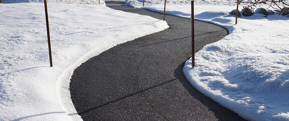 A cleared pathway through a snow covered landscape in Malvern, PA.